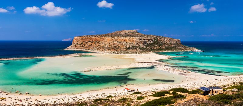 Fantastic panorama of Balos Lagoon and Gramvousa island on Crete, Greece. Cap tigani in the center. Balos beach on Crete island, Greece. Tourists relax and bath in crystal clear water of Balos beach.
