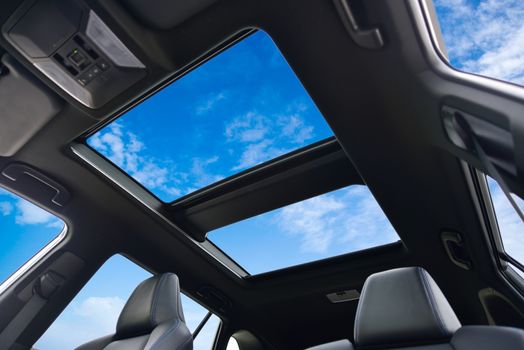 photo large sunroof inside car, sky and clouds