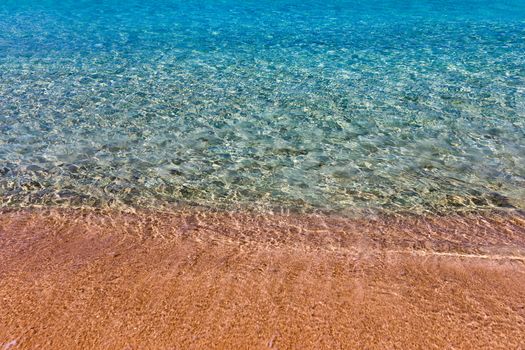 Yellow warm sand and summer sea with sky and free space. Sea, Sand, Sky and summer day. Beach and sea on a summer day, travel concept, vacation and relaxation. Summer sand beach and sea background.