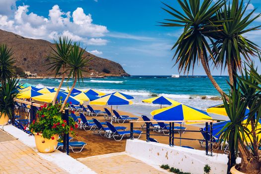 View of sunbeds awaiting tourists at the Greek island resort of Georgioupolis on Crete north coast. Georgioupoli is a resort village and former municipality in the Chania regional unit, Crete, Greece.