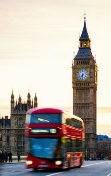London, the UK. Red bus in motion and Big Ben, the Palace of Westminster. The icons of England