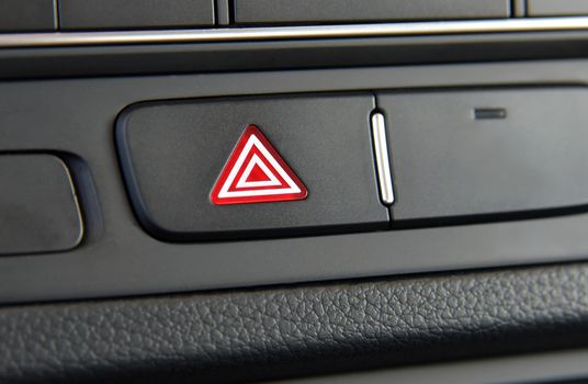 A switch for the hazard lights in the car, car interior detail