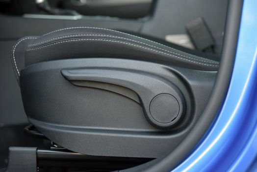 mechanical adjusting lever for adjusting seats in a SUV, car interior detail