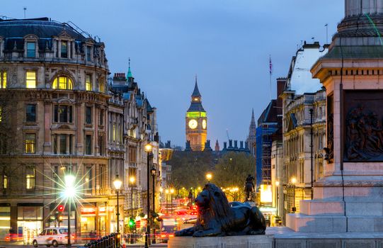 Street view of Trafalgar Square towards Big Ben at night in London, UK