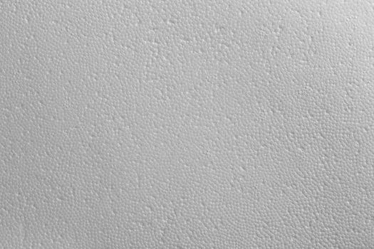Seamless texture of white polystyrene foam or styrofoam, close-up flat white on white background.