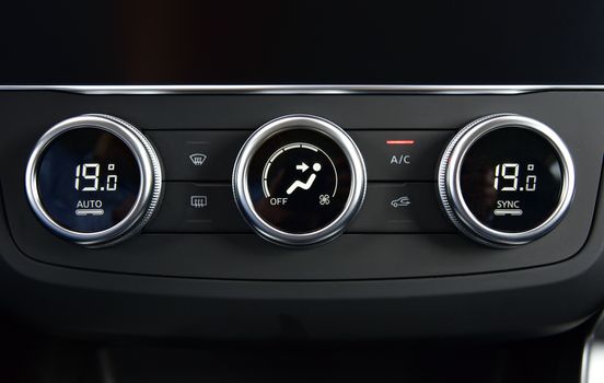 button for activating the air conditioners on the dashboard passenger car