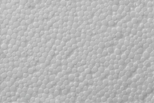 Simple texture of white polystyrene foam or styrofoam, close-up flat white on white background.