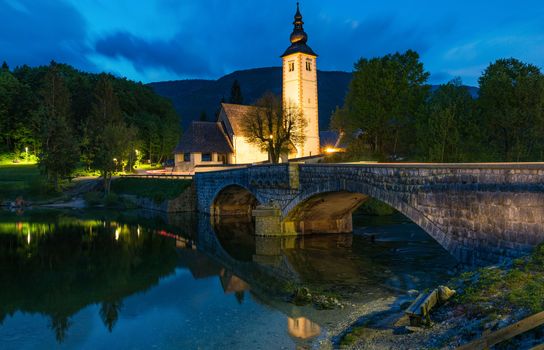 Church of Sv. John the Baptist and a bridge by the Bohinj lake in night, Slovenia. Church of St John the Baptist with bridge. Triglav National Park, Julian Alps, Slovenia, Europe