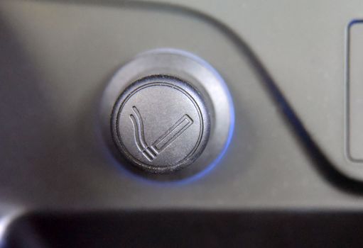 cigarette lighter on the dashboard of a passenger car