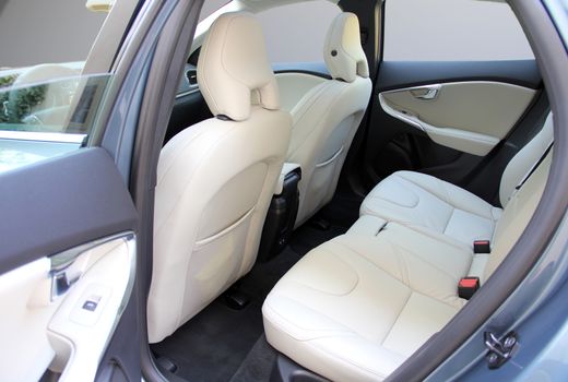 the white rear seat of a luxury passenger car