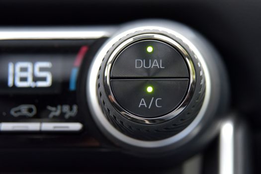 buttons for activating the air conditioners on the dashboard passenger car