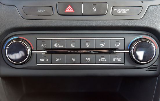 manual switches the air conditioning on the dashboard of the car