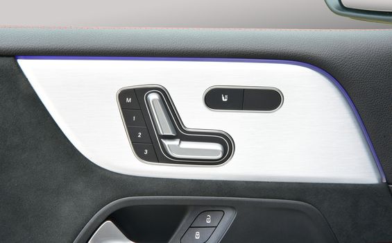 Buttons for adjusting seat position. Car interior detail