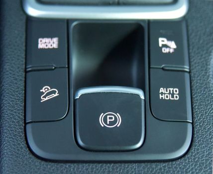 detail in a car with electric parking brake button