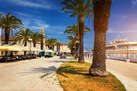 Historic buildings on promenade in Trogir, Croatia. Trogir is popular travel destination in Croatia. Trogir, as a UNESCO World Heritage Site, is one of most visited places in Dalmatia, Croatia.