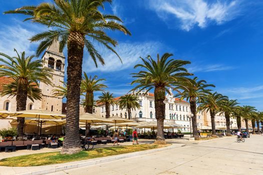 Historic buildings on promenade in Trogir, Croatia. Trogir is popular travel destination in Croatia. Trogir, as a UNESCO World Heritage Site, is one of most visited places in Dalmatia, Croatia.