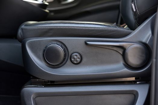 Buttons for adjusting seat position. Car interior detail