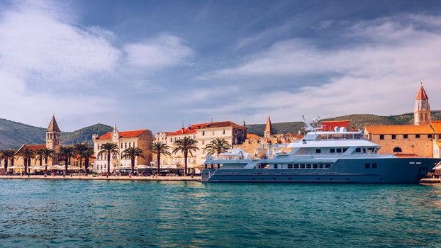 Historic buildings on promenade in Trogir, Croatia. Trogir is popular travel destination in Croatia. Trogir, as a UNESCO World Heritage Site, is one of most visited places in Dalmatia, Croatia.