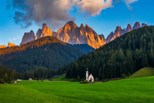 Landscapes with San Giovanni Church and small village in Val di Funes, Dolomite Alps, South Tyrol, Italy, Europe. San Giovanni in Ranui church (St John in Ranui church) in the Dolomites, Italy.