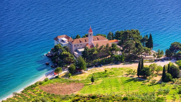 View of beautiful bay with beach and Dominican monastery in Bol town, Brac island, Croatia. Dominican monastery in Bol, built in 15th century. Bol town, Brac island, Croatia.