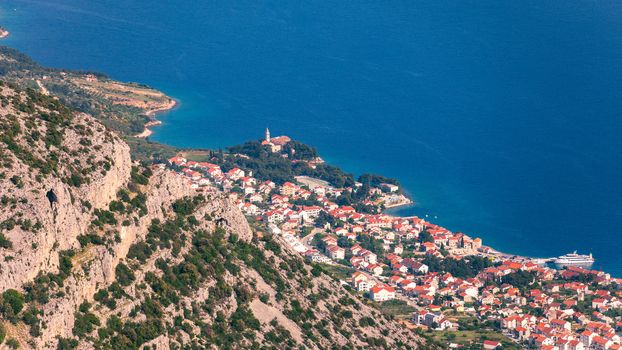 View on mountains and sea from Vidova Gora on Brac island. View from the mountain Vidova Gora on the island Brac in Croatia with the famous landmark Zlatni Rat near the city of Bol an the blue sea.