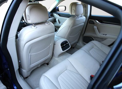 the white rear seat of a luxury passenger car