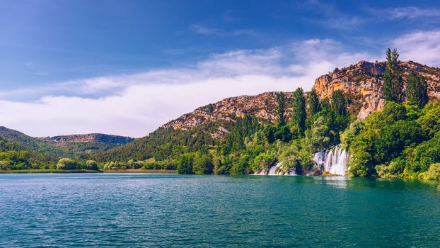 Waterfalls Krka, National Park, Dalmatia, Croatia. View of Krka National Park, Roski Slap location, Croatia, Europe. Beautiful world of Mediterranean countries. Traveling concept background.