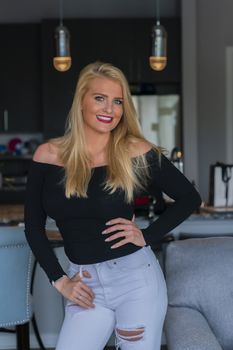 A gorgeous blonde model enjoys a day at home before work