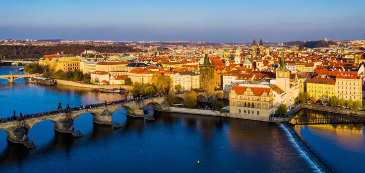 Aerial Prague panoramic drone view of the city of Prague at the Old Town Square, Czechia. Prague Old Town pier architecture and Charles Bridge over Vltava river in Prague at sunset, Czech Republic. 