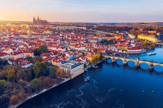 Aerial Prague panoramic drone view of the city of Prague at the Old Town Square, Czechia. Prague Old Town pier architecture and Charles Bridge over Vltava river in Prague at sunset, Czech Republic. 