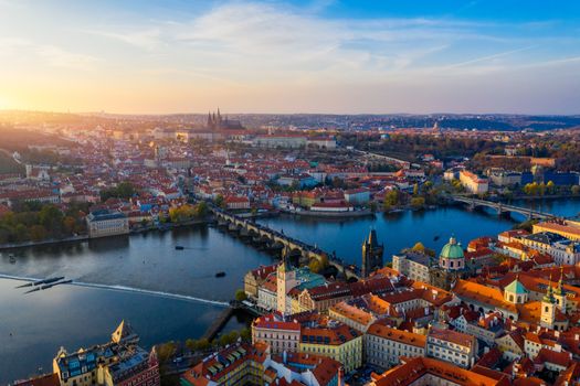 Aerial Prague panoramic drone view of the city of Prague at the Old Town Square, Czechia. Prague Old Town pier architecture and Charles Bridge over Vltava river in Prague at sunset, Czech Republic. 