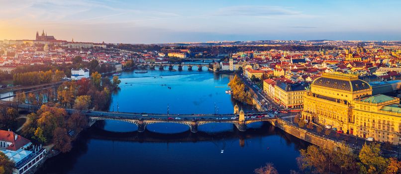 Aerial Prague panoramic drone view of the city of Prague at the Old Town Square, Czechia. Prague Old Town pier architecture and Charles Bridge over Vltava river in Prague at sunset, Czech Republic. 