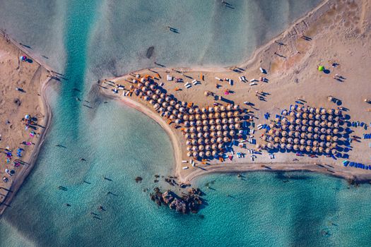 Aerial view of beautiful tropical Elafonissi Beach with pink sand. View of a nice tropical Elafonissi beach from the air. Beautiful sky, sea, resort. Elafonissi beach, Crete, Greece.
