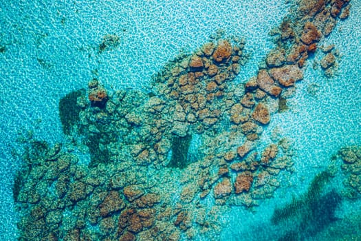 Sea surface aerial view. Background image of the turquoise sea. Deep sea and corals. Aerial drone shot of turquoise water, space for text. Aquamarine background. Sea Aerial view.