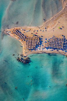 Aerial drone shot of beautiful turquoise beach with pink sand Elafonissi, Crete, Greece. Best beaches of Mediterranean, Elafonissi beach, Crete, Greece. Famous Elafonisi beach on Greece island, Crete.