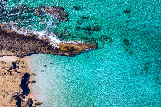 People swimming in the sea. Aerial view, Top view. The color of the water and beautifully bright. Swimming and relaxing in the sea blue lagoon aerial top view. Top view from flying drone.