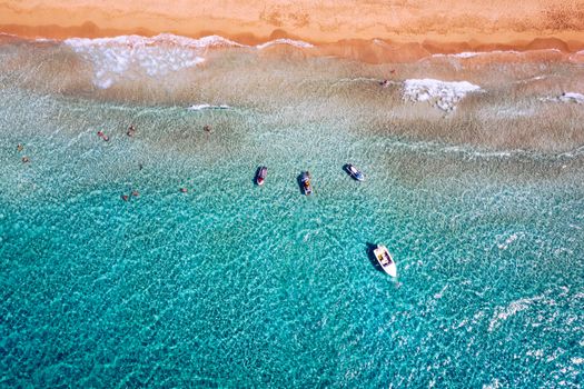 People swimming in the sea. Aerial view, Top view. The color of the water and beautifully bright. Swimming and relaxing in the sea blue lagoon aerial top view. Top view from flying drone.