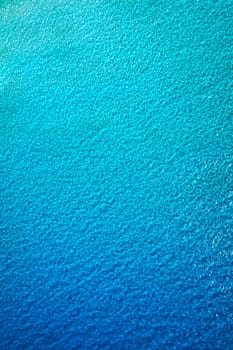 Sea surface aerial view. Background image of the turquoise sea. Deep sea and corals. Aerial drone shot of turquoise water, space for text. Aquamarine background. Sea Aerial view.
