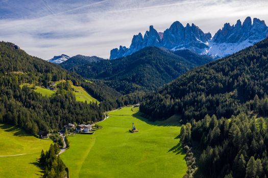 Beautiful landscape with Italian Alps and Church of Saint John located in Ranui, Italy. Val di Funes, Bolzano, Italy. San Giovanni in Ranui church (St John in Ranui church) in the Dolomites, Italy.