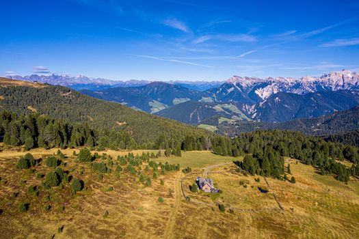 Stunning view of Peitlerkofel mountain from Passo delle Erbe in Dolomites, Italy. View of Sass de Putia (Peitlerkofel) at Passo delle Erbe, with wooden farm houses, Dolomites, South Tyrol, Italy.