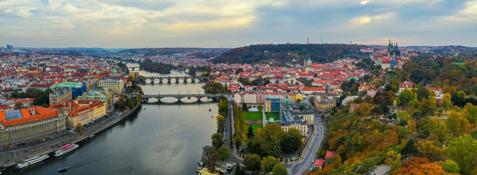Aerial Prague panoramic drone view of the city of Prague at the Old Town Square, Czechia. Prague Old Town pier architecture and Charles Bridge over Vltava river in Prague at sunset, Czech Republic. 