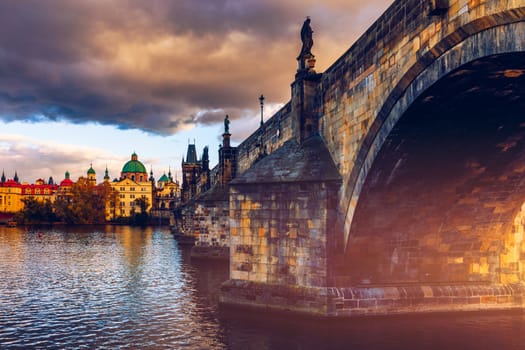Autumn view to Charles bridge on Vltava river in Prague, Czech Republic. Autumn view to Charles Bridge, Prague old town and Vltava river. Czechia. Scenic autumn view of the Old Town with red foliage.
