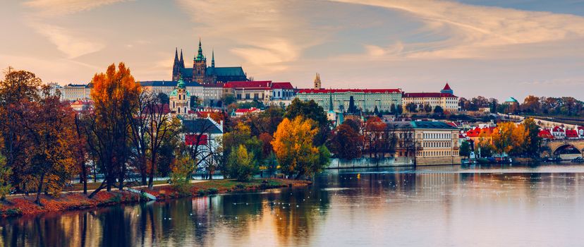 Prague autumn landscape. Prague autumn landscape view to Saint Vitus cathedral. Prague. Prague panorama. Prague, Czech Republic. Scenic autumn aerial view of the Old Town with red foliage. Czechia.
