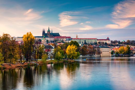 Autumn view to Charles bridge on Vltava river in Prague, Czech Republic. Autumn view to Charles Bridge, Prague old town and Vltava river. Czechia. Scenic autumn view of the Old Town with red foliage.
