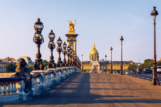 Pont Alexandre III bridge over river Seine in the sunny summer morning. Bridge decorated with ornate Art Nouveau lamps and sculptures. The Alexander III Bridge across Seine river in Paris, France.