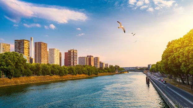 Towers and skyscrapers in Paris, France, used as office buildings as well as office buildings, by the water in front of barges on the river Seine in Quai de Grenelle, Front-de-Seine District. Paris
