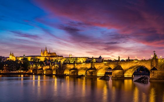 Charles Bridge in Prague in Czechia. Prague, Czech Republic. Charles Bridge (Karluv Most) and Old Town Tower. Vltava River and Charles Bridge. Concept of world travel, sightseeing and tourism.