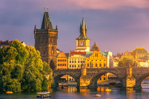 Prague Castle, Charles Bridge and boats on the Vltava river. View of Hradcany Prague Castle, Charles Bridge and a boats on the Vltava river in the capital of the Czechia. Boat cruise on Vltava river.