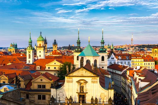 Scenic summer aerial panorama of the Old Town architecture in Prague, Czech Republic. Red roof tiles panorama of Prague old town.  Prague Old Town Square houses with traditional red roofs. Czechia.