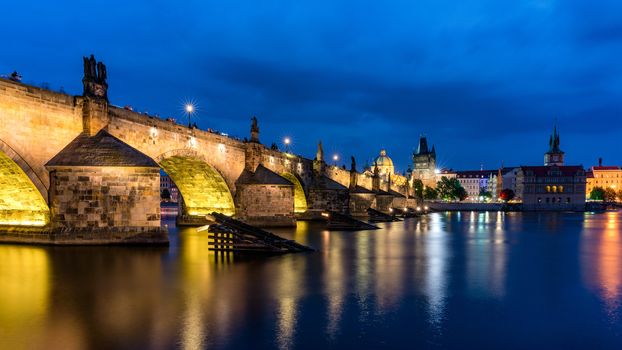 Charles Bridge in Prague in Czechia. Prague, Czech Republic. Charles Bridge (Karluv Most) and Old Town Tower. Vltava River and Charles Bridge. Concept of world travel, sightseeing and tourism.
